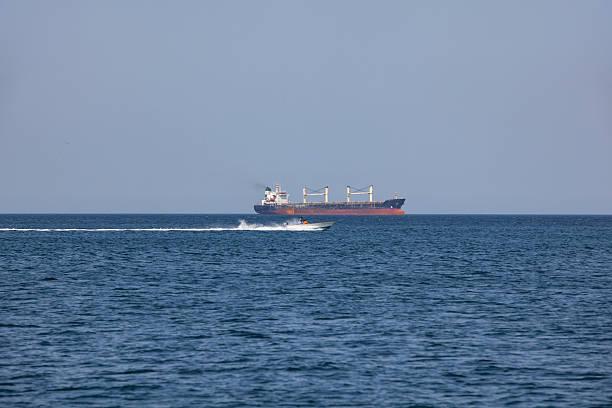Large cargo ship passing through thestrait of hormuz