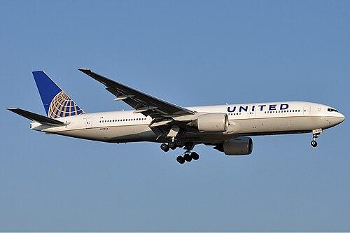 A United Airlines Boeing descending on final approach with its landing gear extended.