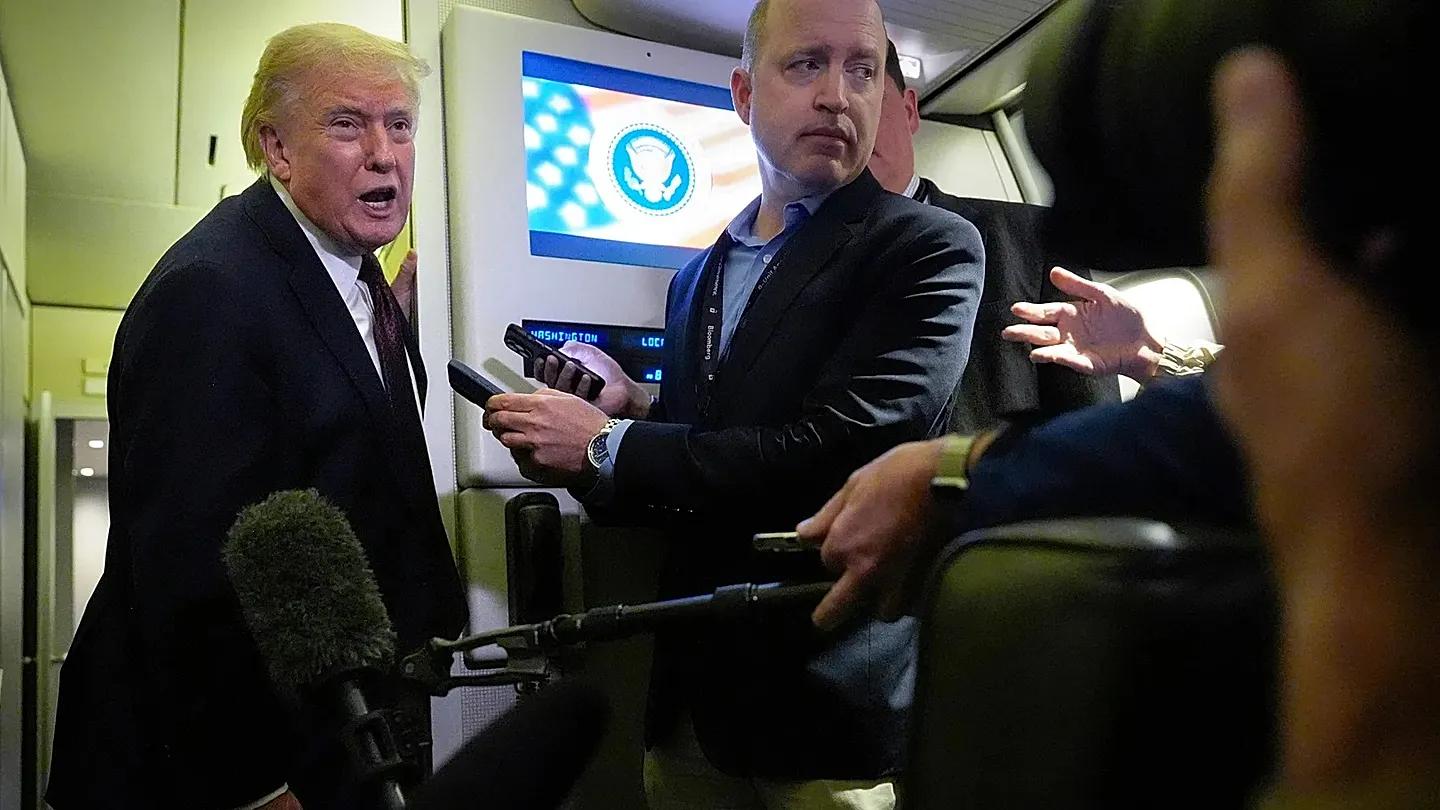 Trump on air force one taking questions from reporters